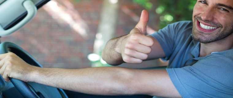 Man in blue shirt driving 