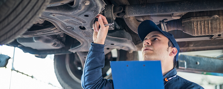 Technician inspecting a car tyre