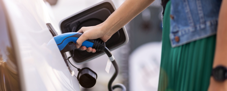 Woman charging electric car port