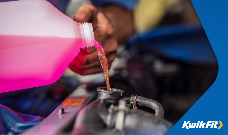 Technician pouring engine coolant into a car.