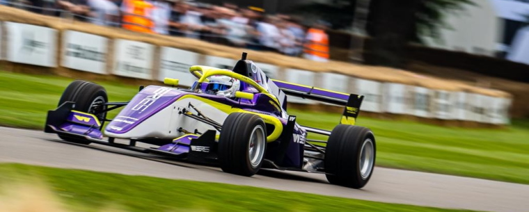 Vehicle racing around Goodwood track