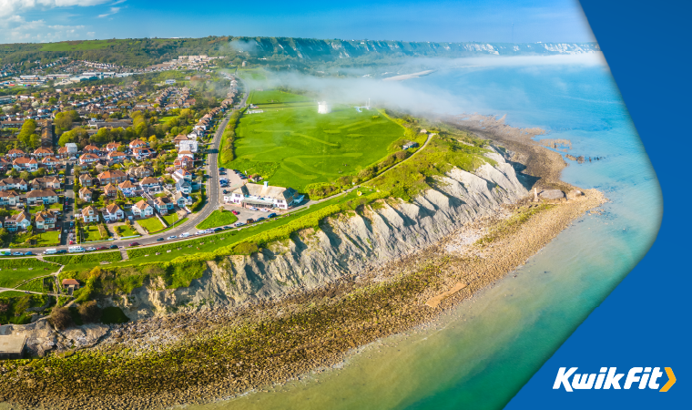 The Kentish Coast surrounded by houses, fields, chalky cliffs and the sea.