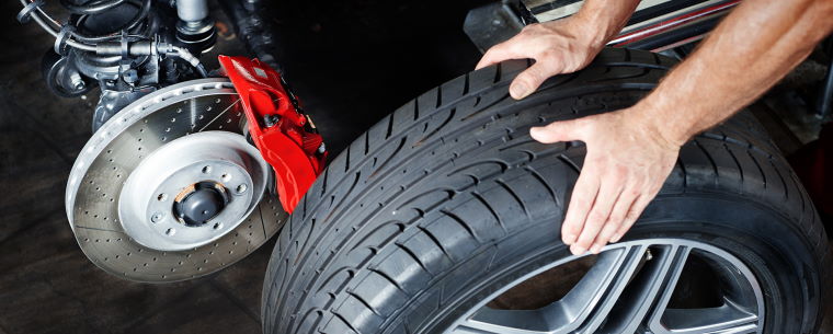 Technician changing a car tyre